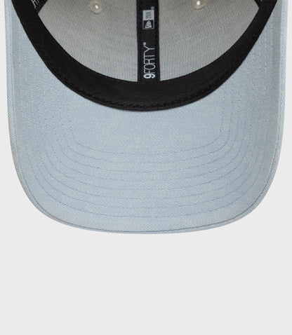 Creme Alpine Acid Wash 9Forty cap with light denim crown and black visor, featuring a vertical 9FORTY label.