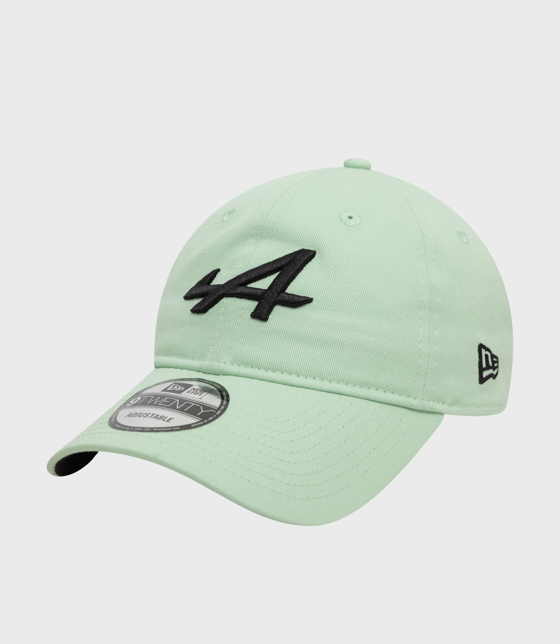 Mint green Alpine 9Twenty cap close up showing crown top button and black front embroidery.