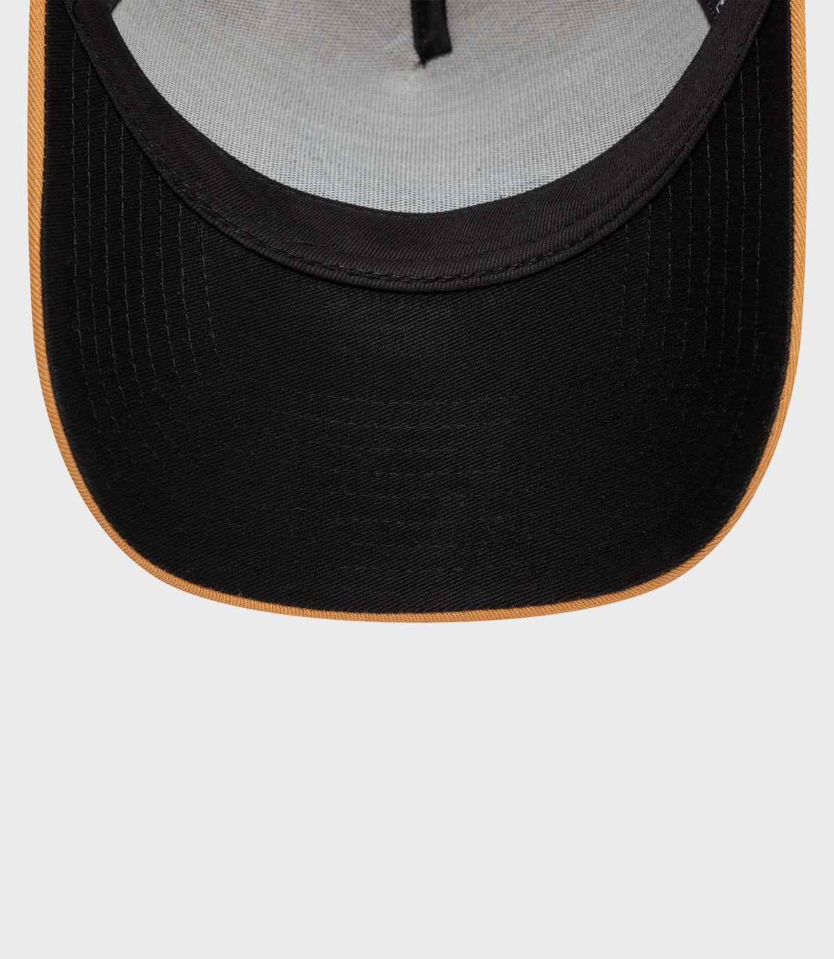 Close-up of beige front panel and black curved brim with gray interior fabric