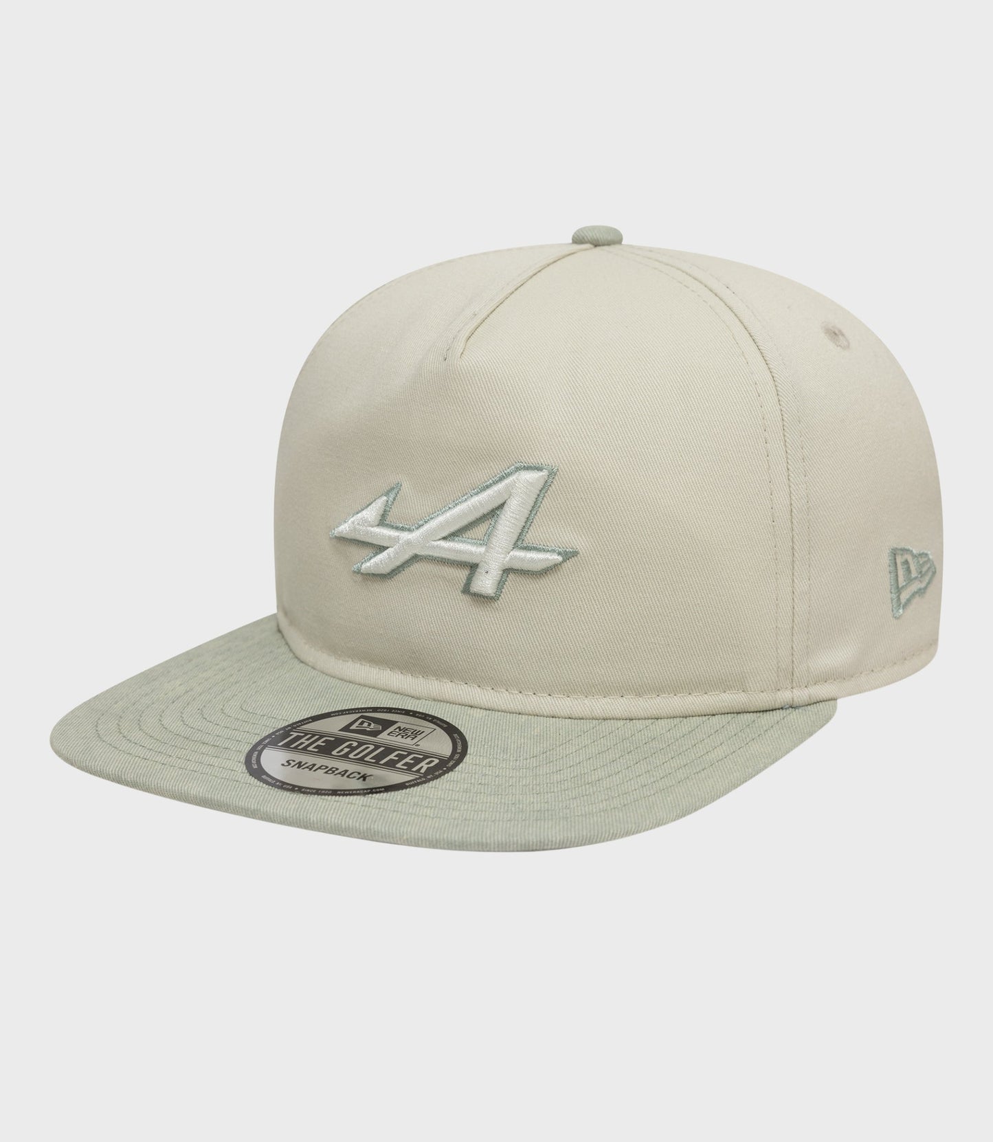 Front and top view of the New Era Alpine Acid Wash Golfer Cap in off white with the top button and front embroidery.