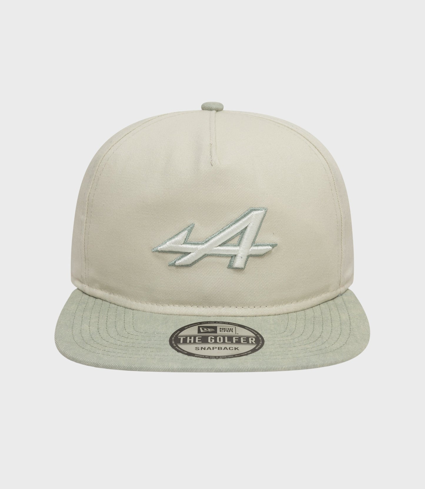 Angled shot of the Alpine Acid Wash Golfer Cap in white, highlighting crown stitching and the embroidered front logo.