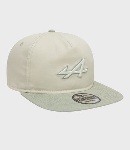 Beige Alpine Acid Wash Golfer Cap with mint brim, featuring the embroidered logo on the front and a sticker on the brim.