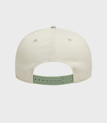 Rear view of white New Era Alpine acid wash golfer cap with a mint green adjustable strap.