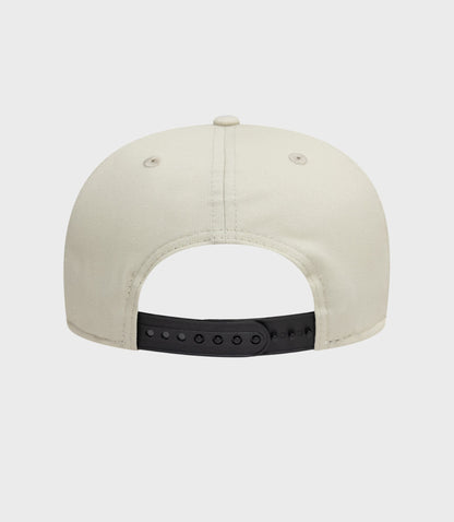 Rear view of cream New Era Alpine Seasonal 9Fifty Pre-Curve cap with a black adjustable strap.