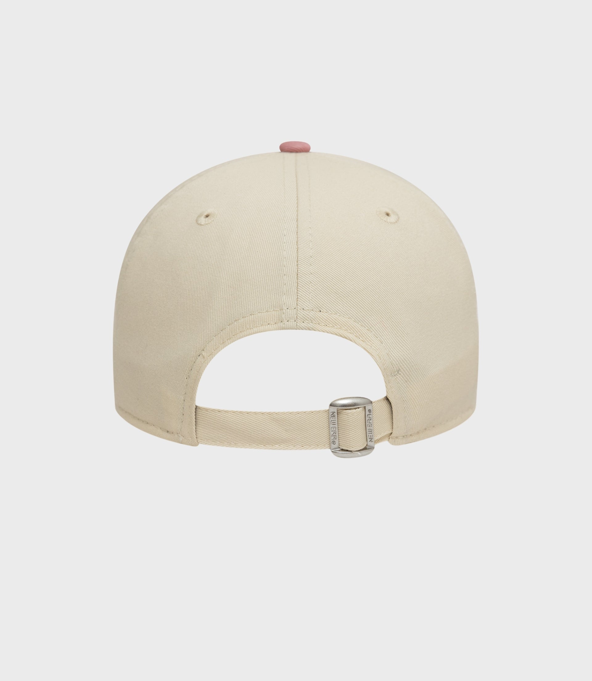 Back view of a light beige New Era cap with an adjustable cotton strap and pink top button.