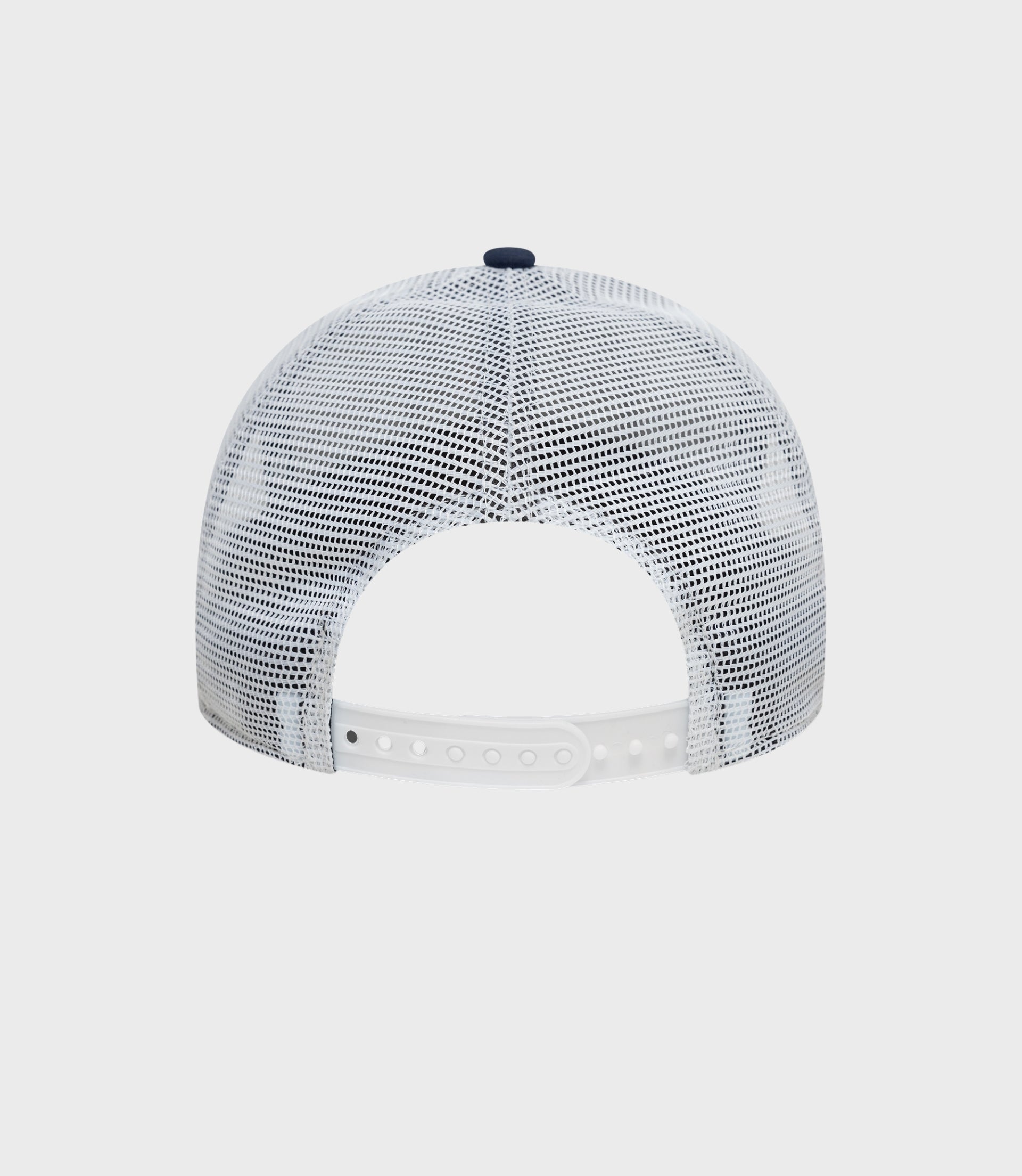 Top view of white mesh trucker cap showing navy button and breathable mesh crown