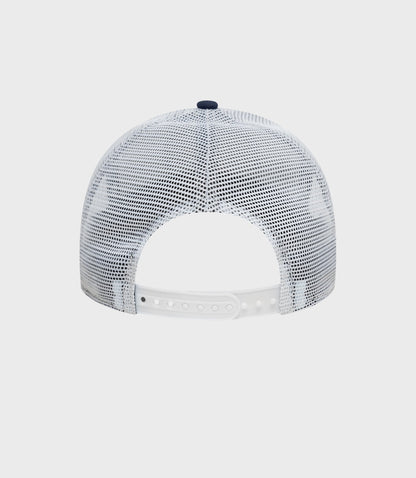 Top view of white mesh trucker cap showing navy button and breathable mesh crown
