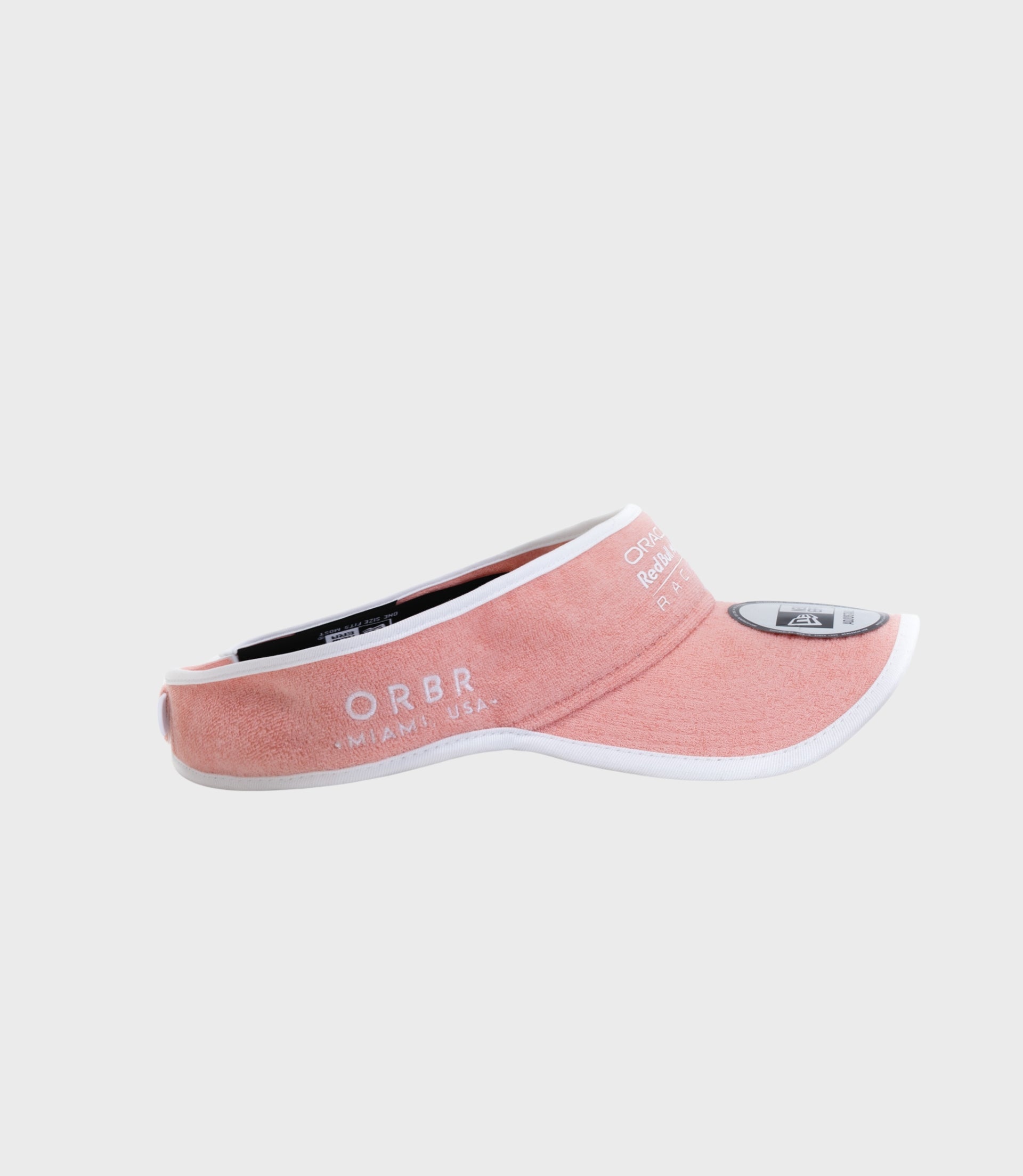Side view of pastel pink visor cap with white trim and visible branding on the crown