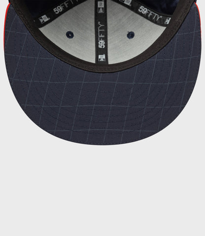 Interior view of navy blue 59FIFTY cap showing under brim stitching and inner branding tape.