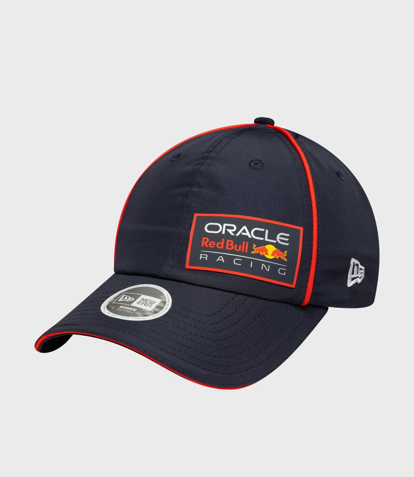 Dark blue open back cap with red piping along the crown and a small top button