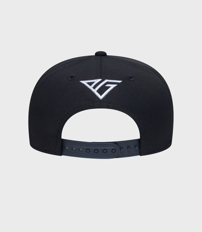 Back view of navy cap showing white embroidered emblem and adjustable snap closure