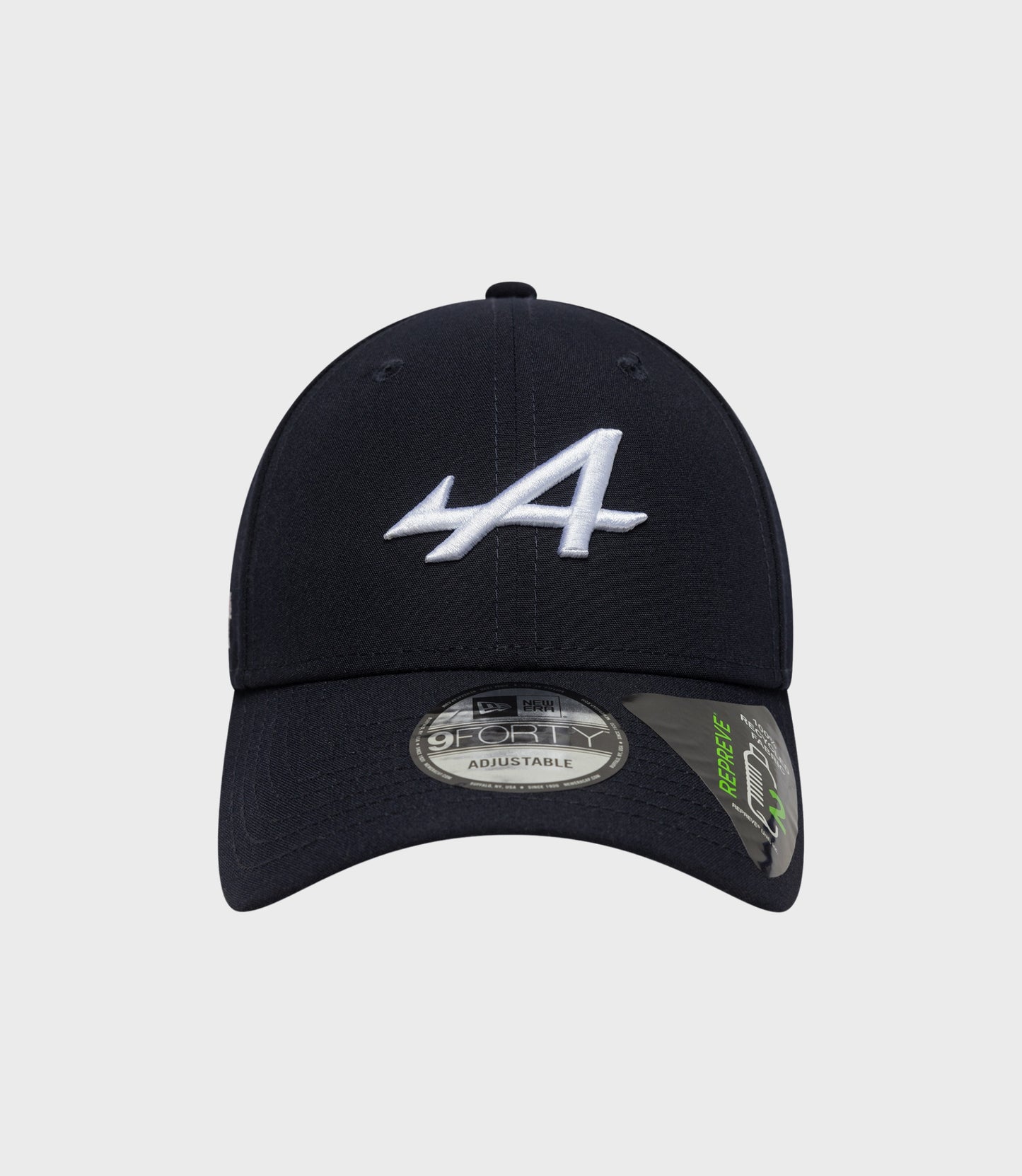 Top-front angle of navy cap with white embroidered logo and visible crown stitching
