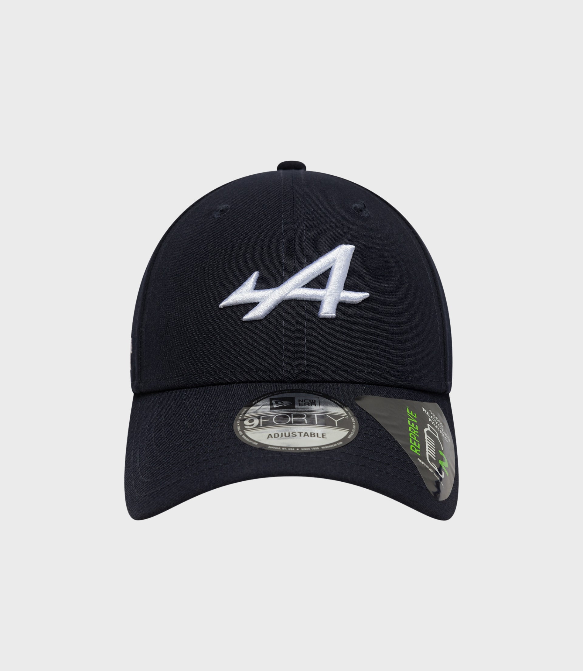 Top-front angle of navy cap with white embroidered logo and visible crown stitching