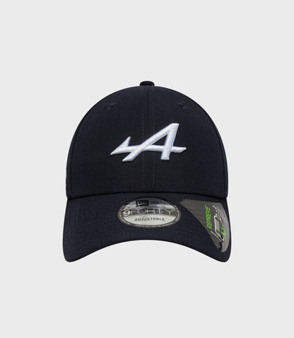 Top-front angle of navy cap with white embroidered logo and visible crown stitching