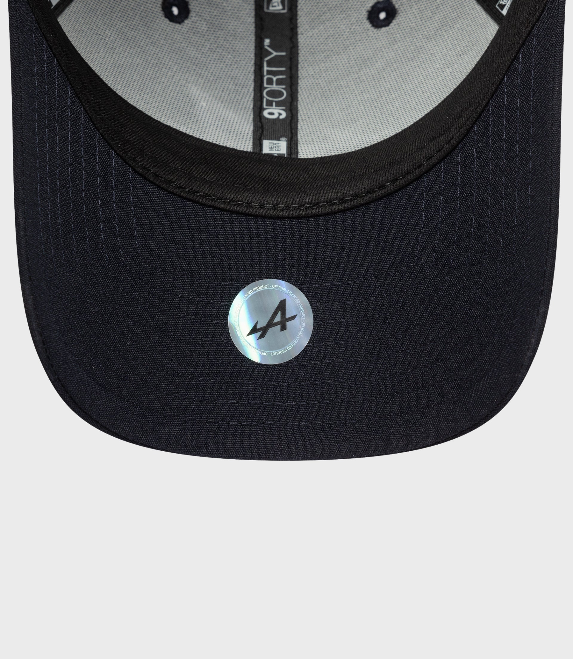 Interior view of navy Repreve 9Forty cap with gray lining and inner label