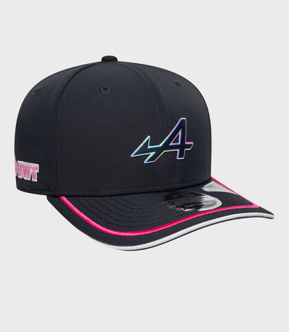 Angled front view of navy cap highlighting the gradient logo and pink brim trim