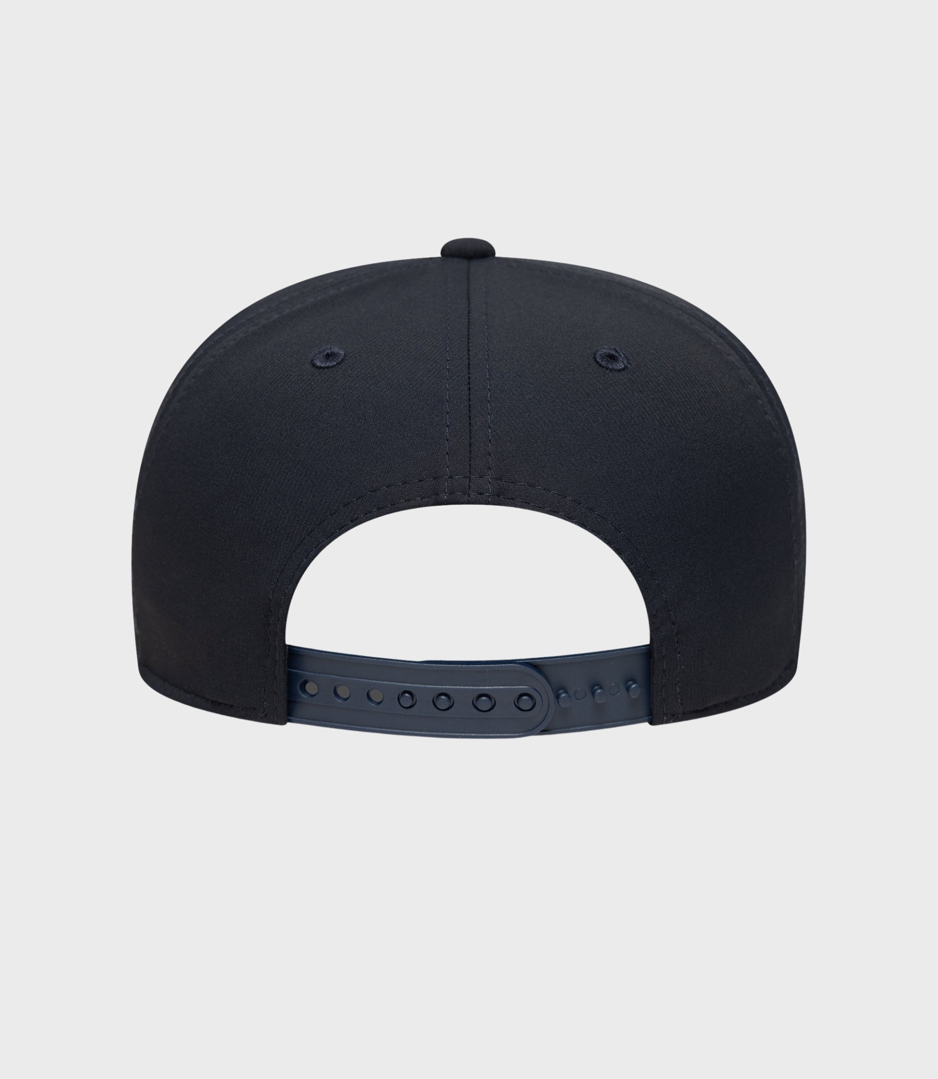 Back view of navy New Era Rep Team 9Seventy stretch snap cap with plastic snap closure