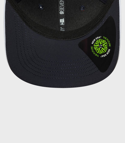 Navy New Era Rep Team 9Seventy stretch snap cap close up showing curved brim and stitched crown