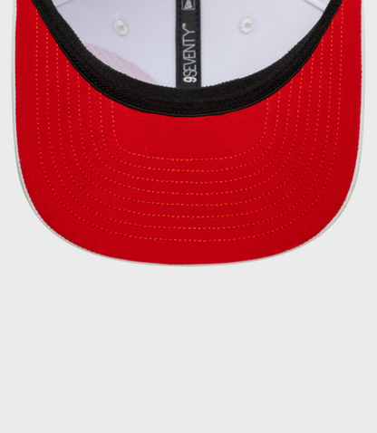 Close-up of red 9Seventy cap brim with black underbill and orange stitching