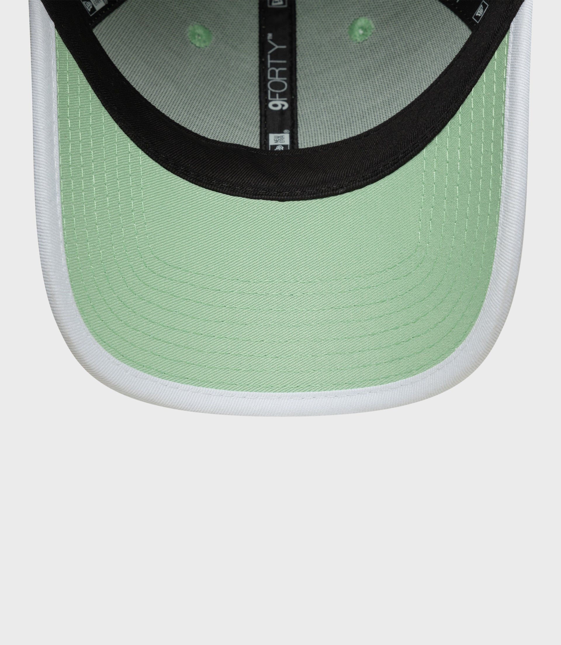 Back view of pastel green cap showing adjustable strap and metal buckle