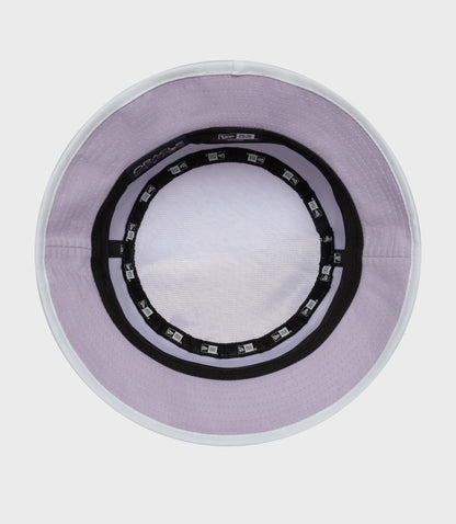 Inside rim of pastel purple bucket hat with white edge and New Era branding tags around the inner band
