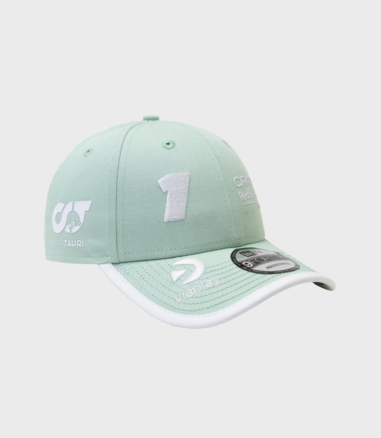 Pastel green cap displaying AlphaTauri and Oracle Red Bull Racing logos with a white trimmed brim
