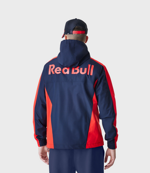 Rear view of model in navy Red Bull Racing Windrunner jacket with large Red Bull lettering across back.