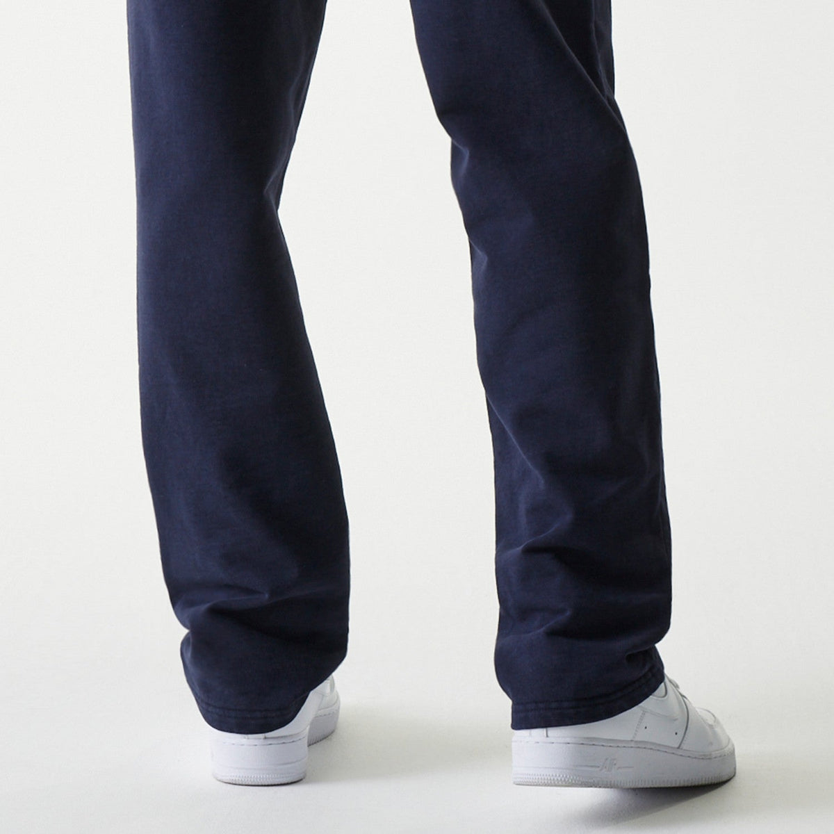 Dark blue New Era Oracle Red Bull Racing joggers worn by a model, back view.