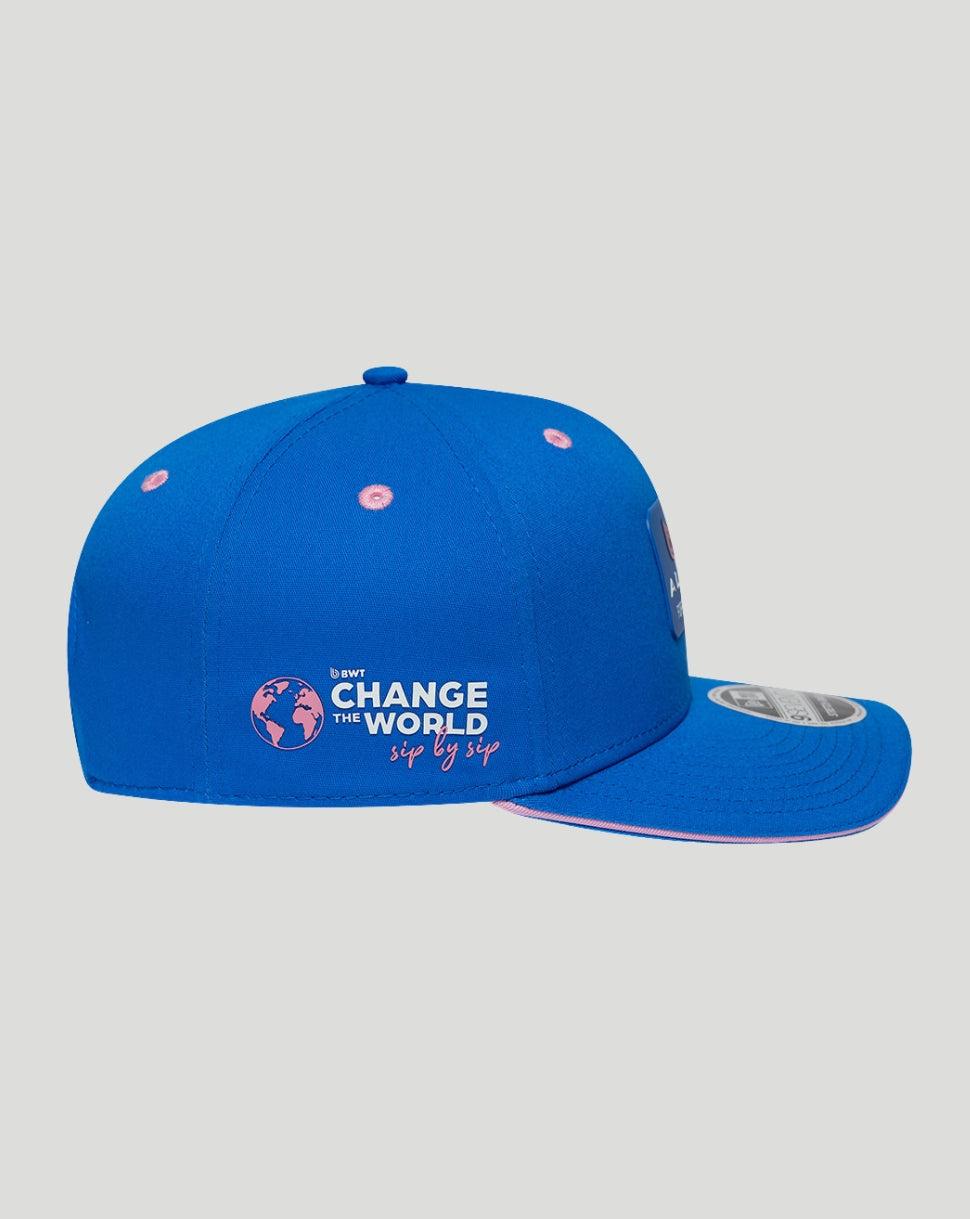 Blue BWT Alpine 9Seventy cap with Change The World sip by sip logo, pink eyelets, and a curved sapphire visor.