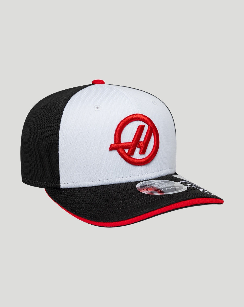 Close up of the white front panel cap showing the red Haas logo and black brim edged in red.