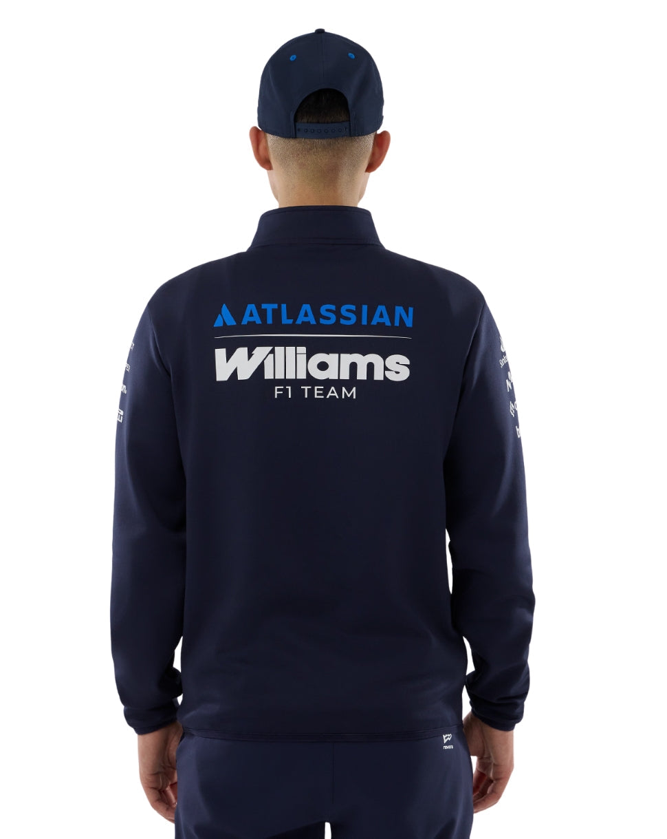 Person wearing a navy jacket with 'Atlassian Williams F1 Team' branding on a white background