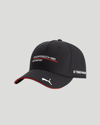 A black Puma Porsche Motorsport baseball cap with white and red branding, shown on a light gray background.