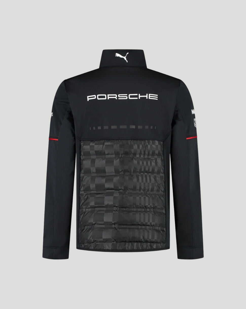 Black Porsche x Puma athletic jacket with a high collar, white Porsche logo on the chest, and a subtle checkerboard pattern on the lower front panel, shown against a light gray background.