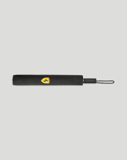 Scuderia Ferrari compact umbrella folded with the yellow crest on black fabric