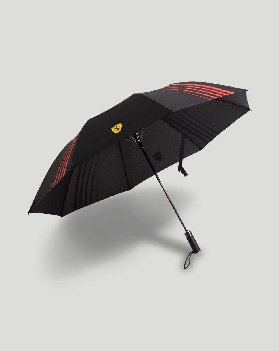 Scuderia Ferrari umbrella opened with a black canopy, red stripes and yellow crest