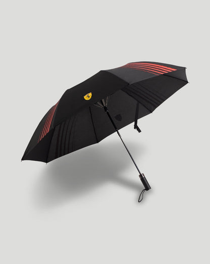 Scuderia Ferrari umbrella opened with a black canopy, red stripes and yellow crest
