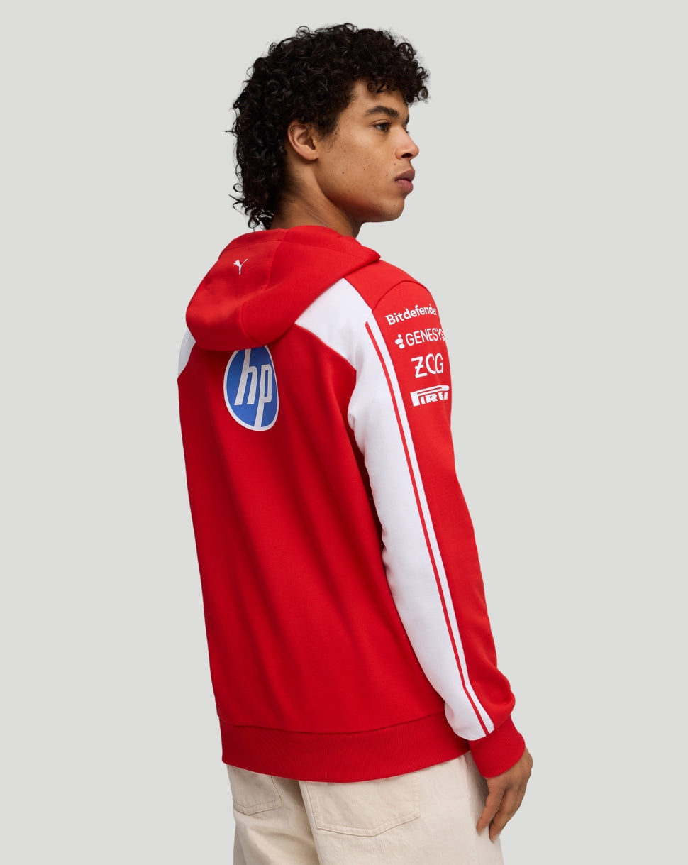 Back view of model in red Ferrari hoodie showing sleeve logos and white piping along the arm