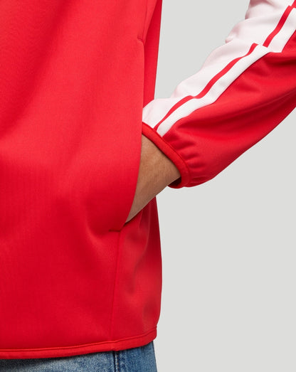 Detail of the red jacket sleeve with a white stripe, cuff, and visible side pocket.