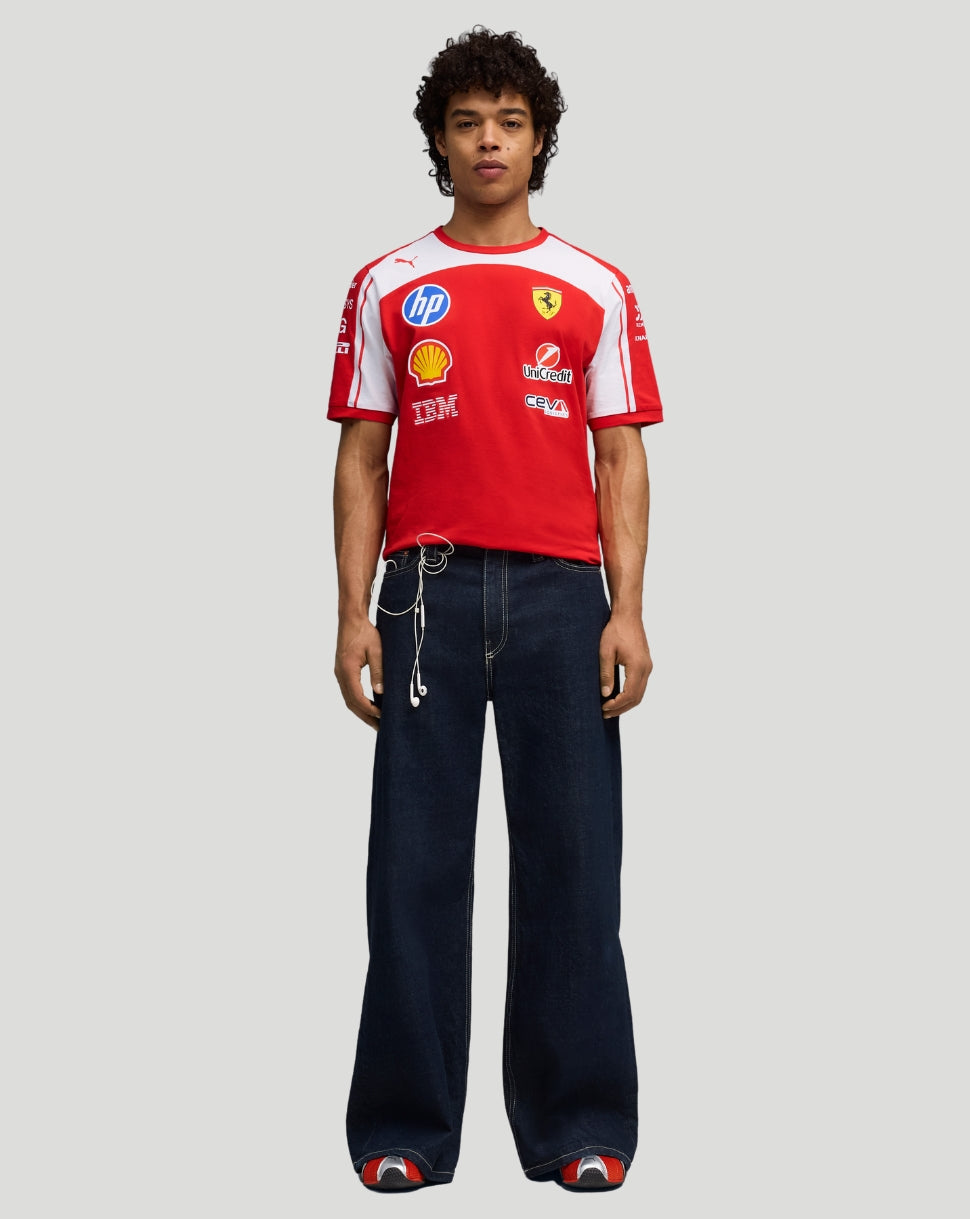 Front view of a model wearing red Scuderia Ferrari team T shirt with white shoulders and sponsor logos across the chest