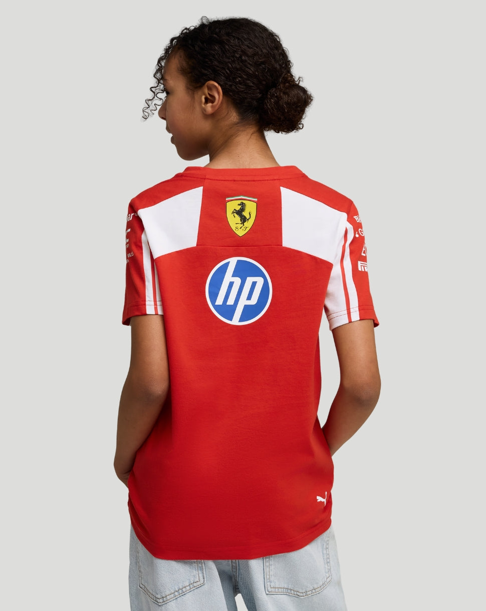 Back view of a child wearing a red Scuderia Ferrari junior team T shirt with a Ferrari crest and hp logo on the back.