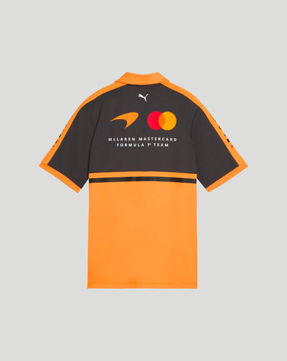Back view of McLaren Women's Team Polo in papaya orange and black with Mastercard Formula 1 Team logos