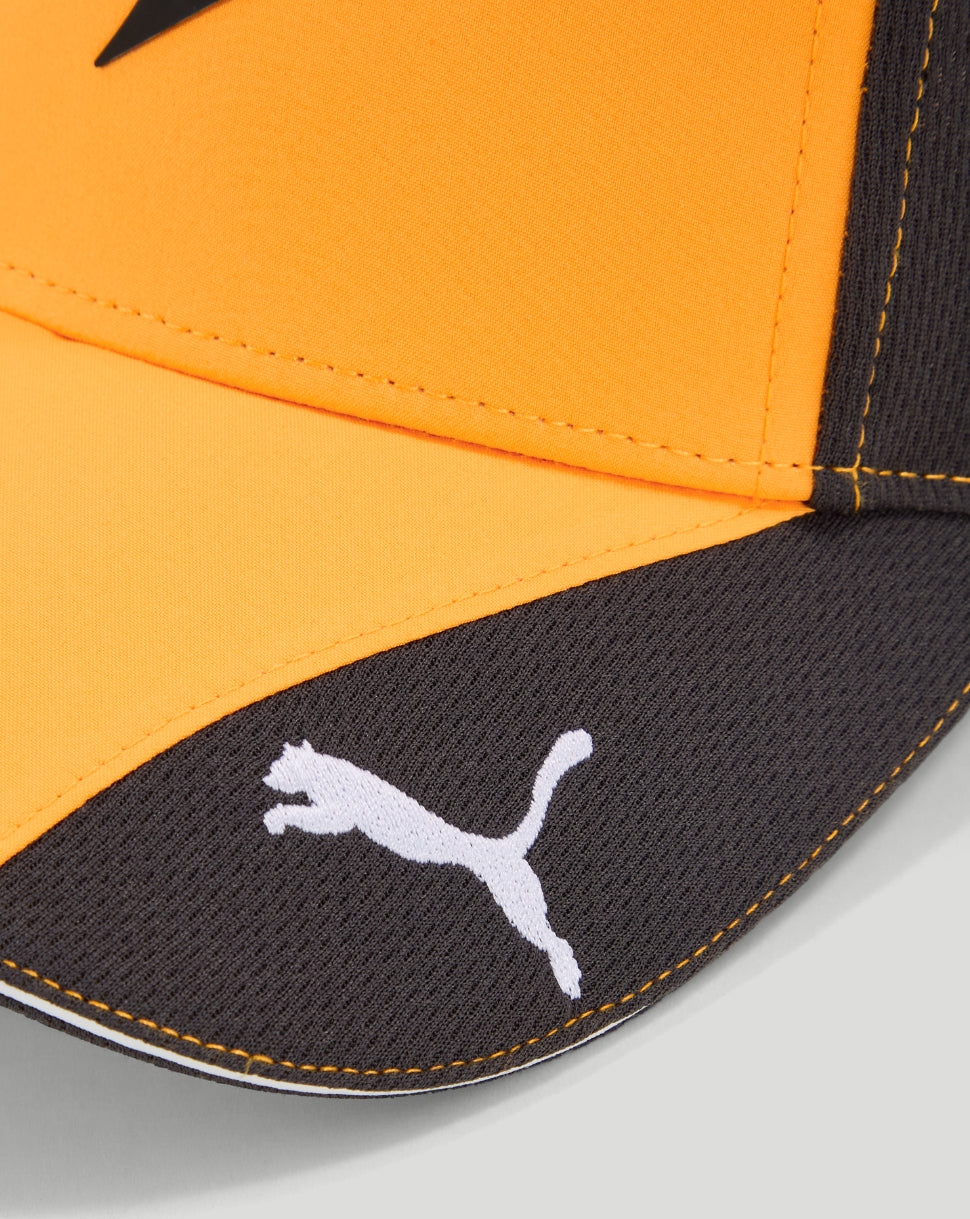 Close up of the dark curved brim with the white Puma logo on the orange cap
