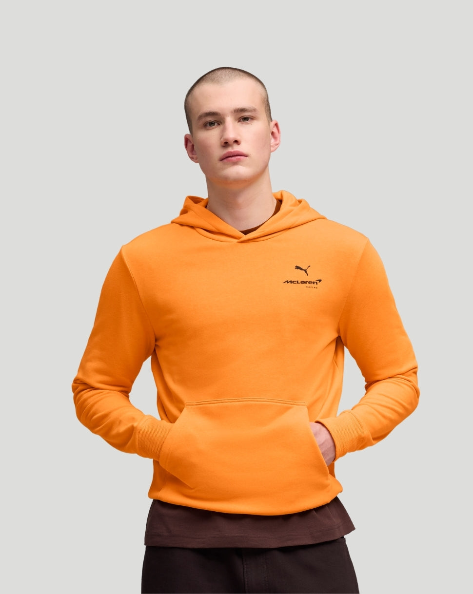 Front view of a model wearing a bright orange McLaren hoodie with a small chest logo.