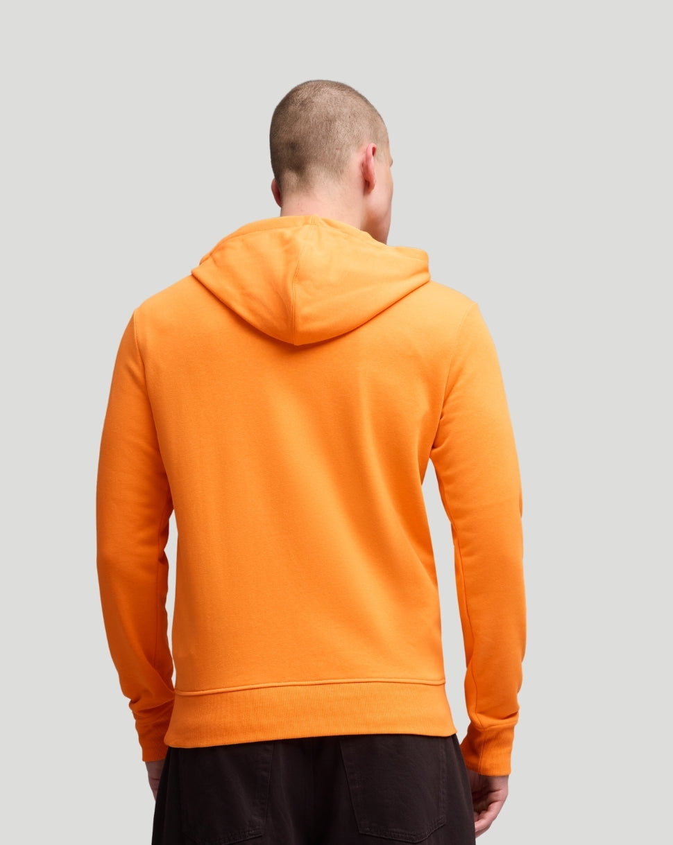 Back view of a bright orange McLaren hoodie on a model.