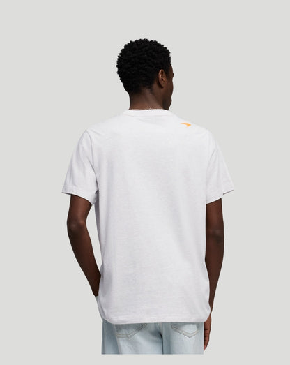 Back view of a white McLaren T Shirt worn by a model with a small orange Speedmark logo on the shoulder.