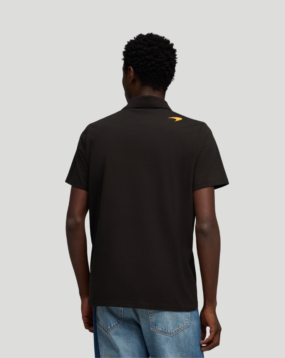 Back view of black McLaren polo featuring a small yellow logo near the collar.