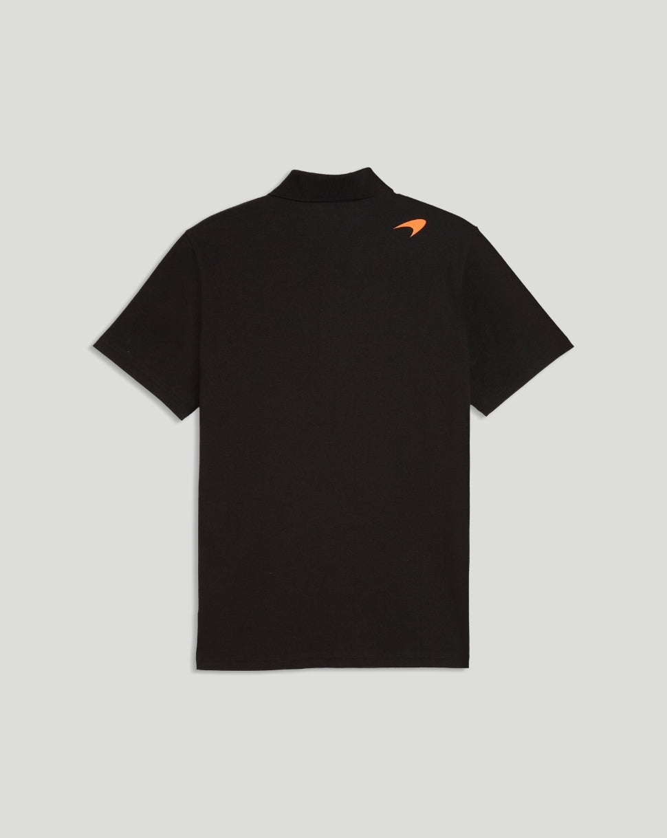 Back view of black McLaren polo shirt with small orange logo on shoulder.