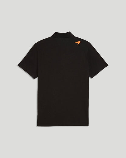 Back view of black McLaren polo shirt with small orange logo on shoulder.