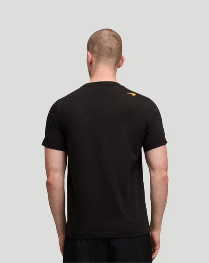 Back view of black McLaren Piastri Core T-Shirt with a small orange Puma logo on the shoulder.