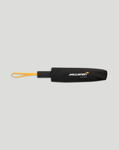 Closed black McLaren umbrella with a yellow wrist strap and McLaren Racing logo